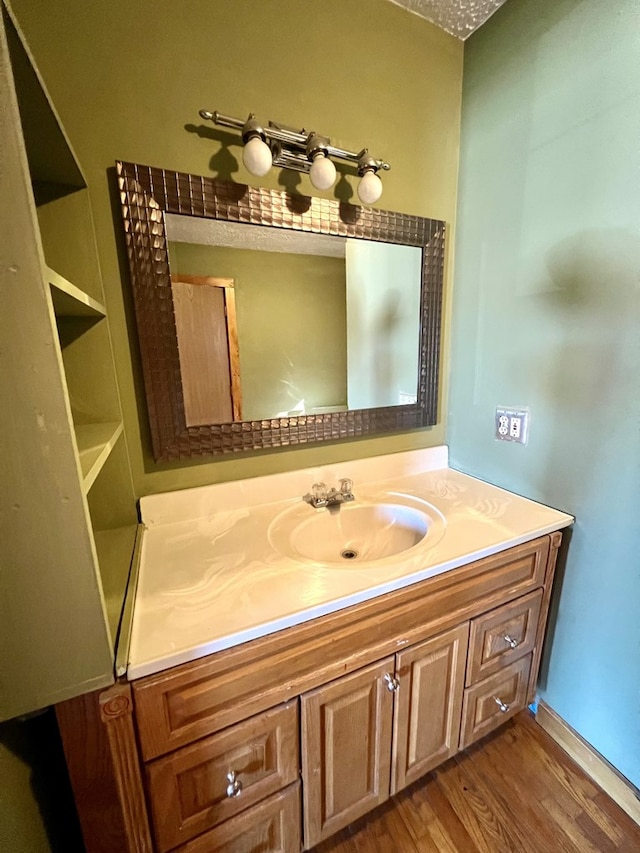 bathroom with vanity and hardwood / wood-style floors