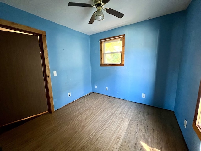 empty room with ceiling fan and hardwood / wood-style floors