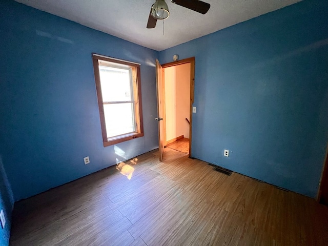 unfurnished bedroom with hardwood / wood-style flooring and ceiling fan