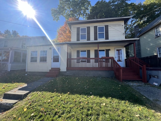 view of front of house featuring covered porch and a front lawn