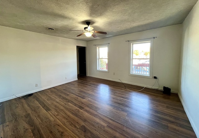 unfurnished room with ceiling fan, dark hardwood / wood-style floors, and a textured ceiling