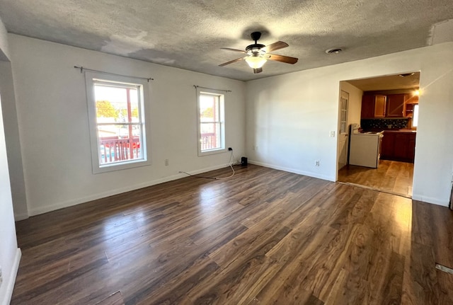 empty room featuring ceiling fan, dark hardwood / wood-style flooring, and a textured ceiling