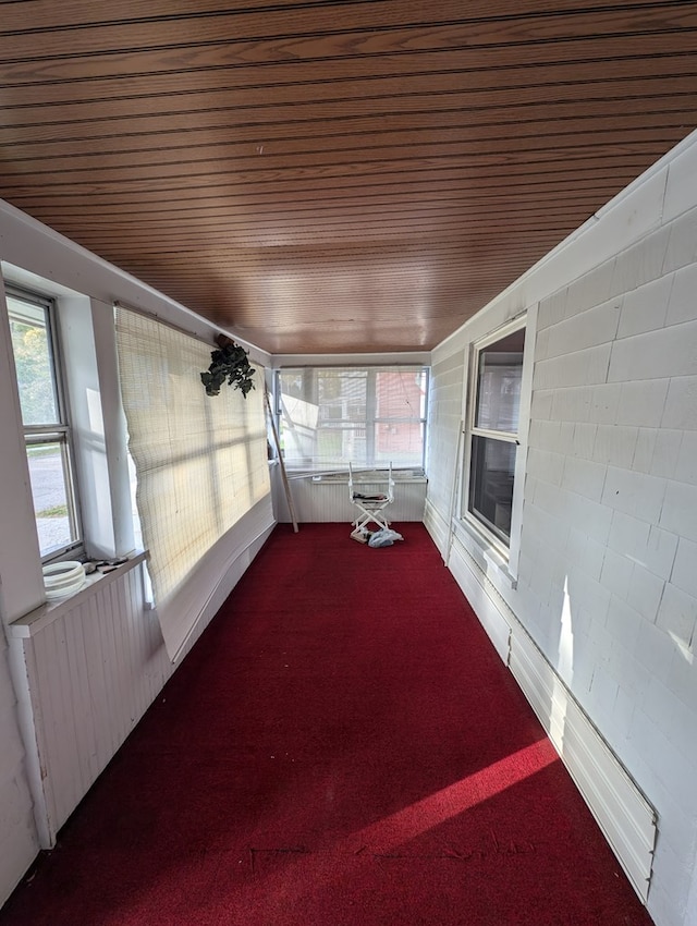 unfurnished sunroom with wood ceiling