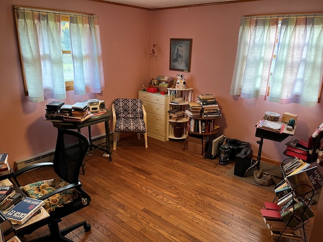 office space featuring hardwood / wood-style flooring and crown molding