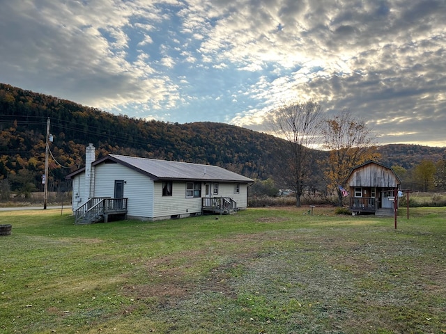 exterior space featuring a deck with mountain view