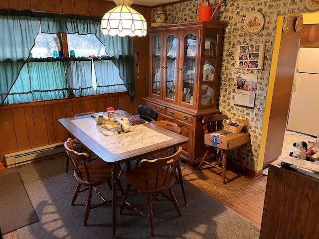 dining room with wood-type flooring and a baseboard radiator