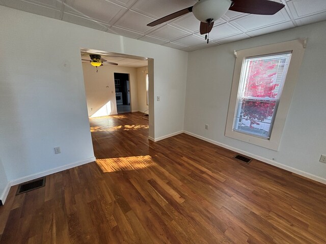 empty room with dark wood-type flooring and ceiling fan