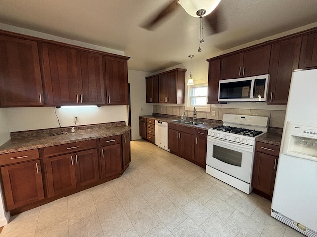 kitchen featuring pendant lighting, sink, decorative backsplash, ceiling fan, and white appliances