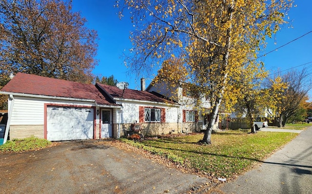 view of front of property with a garage and a front lawn