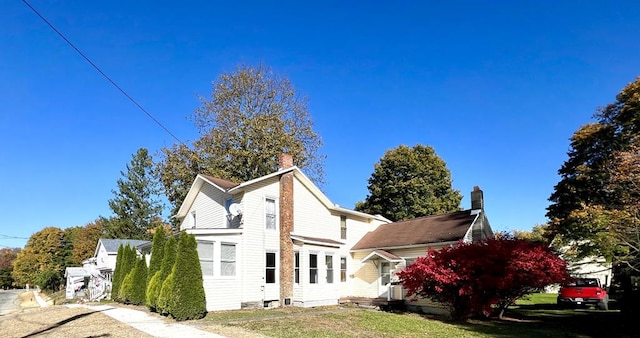 rear view of property featuring a yard