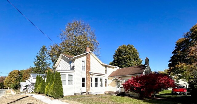 back of property featuring a yard