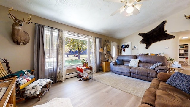 living room featuring a baseboard heating unit, vaulted ceiling, ceiling fan, light wood-type flooring, and a textured ceiling