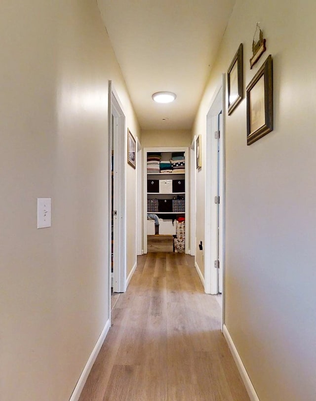 hall with light hardwood / wood-style floors