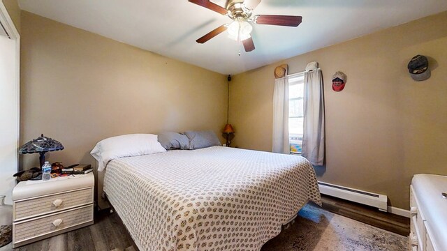 bedroom featuring ceiling fan, dark hardwood / wood-style flooring, and a baseboard heating unit