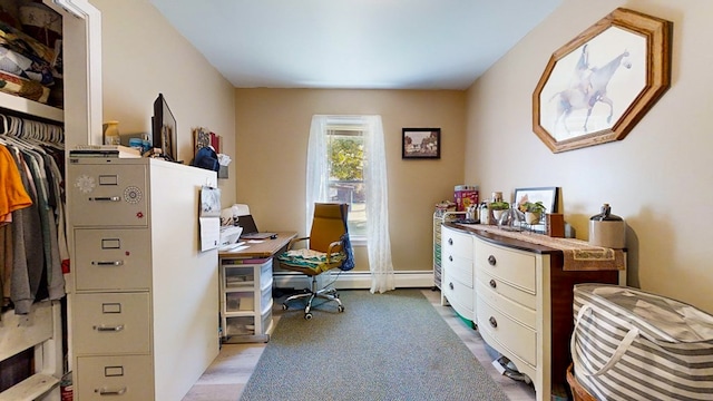 office space featuring light colored carpet and a baseboard heating unit