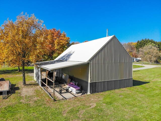 view of side of home with a yard