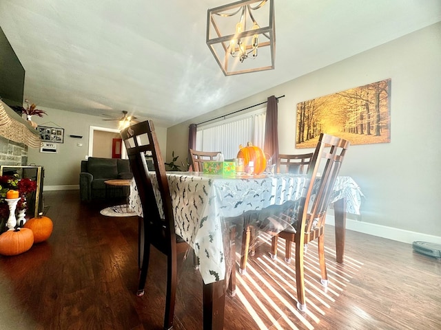 dining room with ceiling fan with notable chandelier and hardwood / wood-style floors