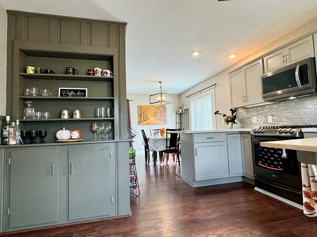 kitchen featuring electric stove, pendant lighting, decorative backsplash, dark wood-type flooring, and kitchen peninsula