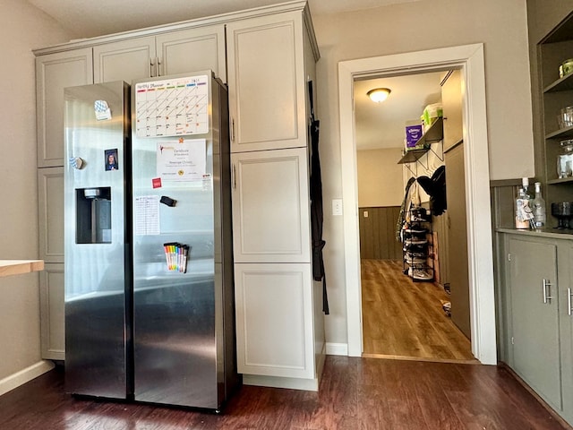 kitchen featuring stainless steel refrigerator with ice dispenser and dark hardwood / wood-style floors