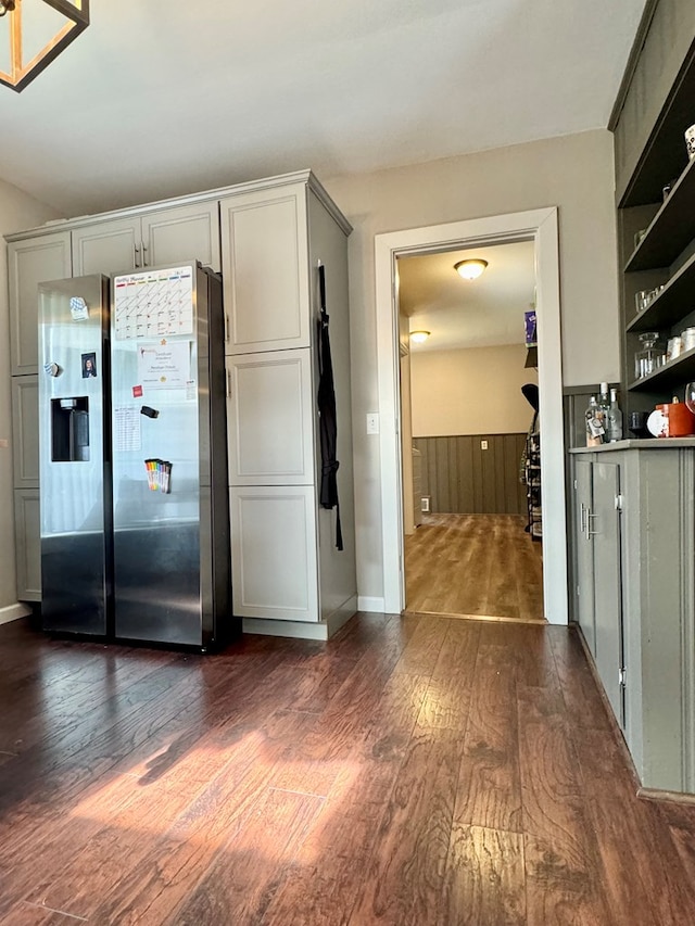 kitchen featuring dark wood-type flooring, gray cabinetry, and stainless steel fridge