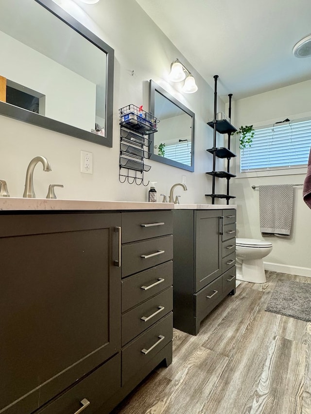 bathroom featuring vanity, hardwood / wood-style flooring, and toilet