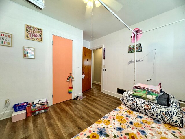 bedroom featuring dark hardwood / wood-style flooring and ceiling fan