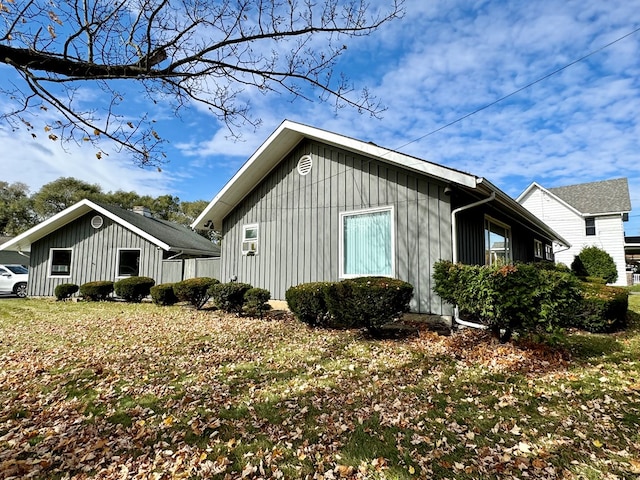 view of side of property with a lawn