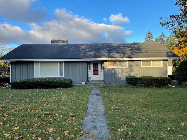 ranch-style home with a front lawn