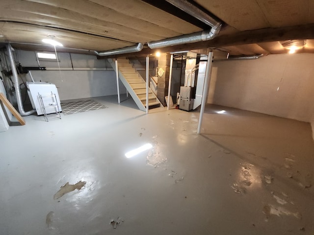 basement with heating unit and washer / dryer