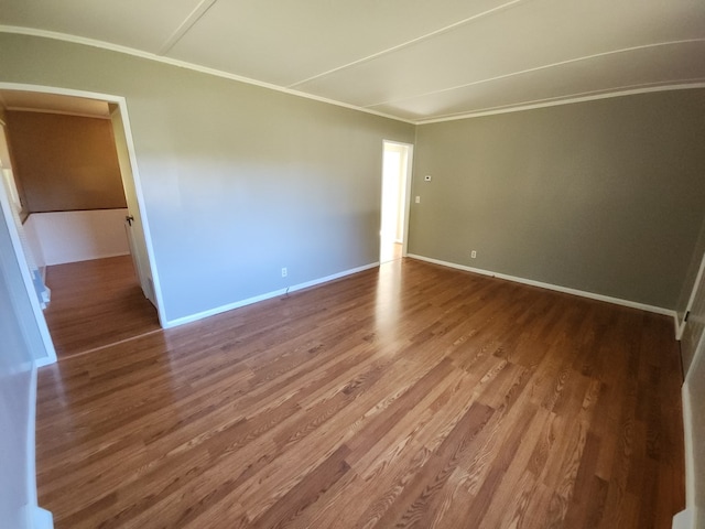 unfurnished room with hardwood / wood-style floors and ornamental molding