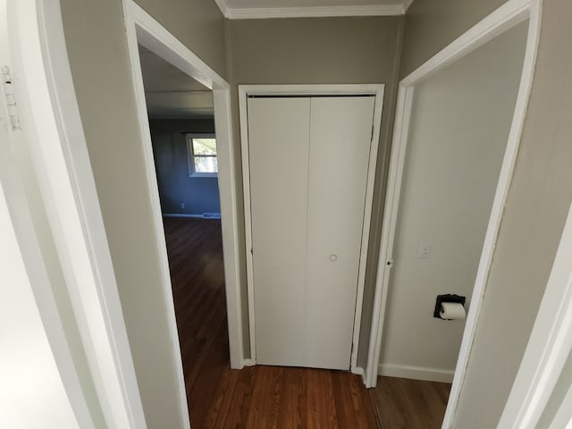 hall with crown molding and dark wood-type flooring