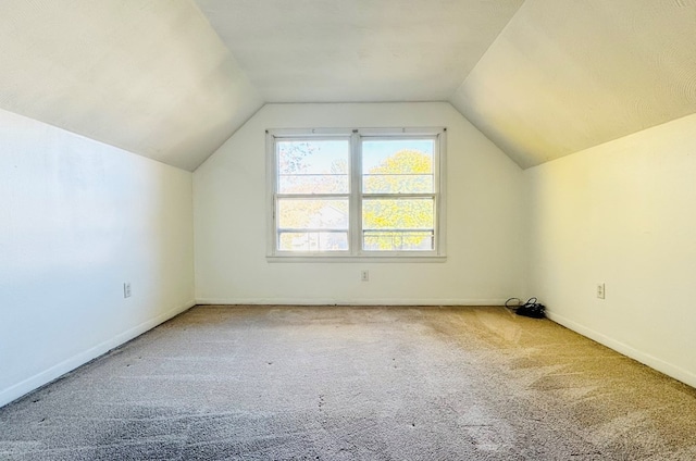 bonus room featuring carpet and vaulted ceiling