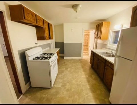 kitchen with sink and white appliances