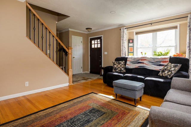 living room with hardwood / wood-style flooring and ornamental molding