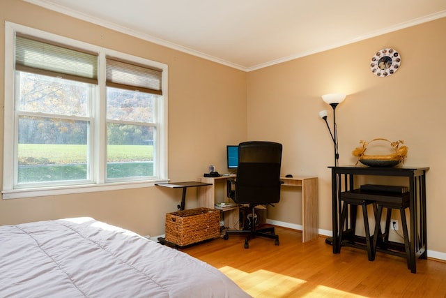 bedroom with hardwood / wood-style floors and ornamental molding