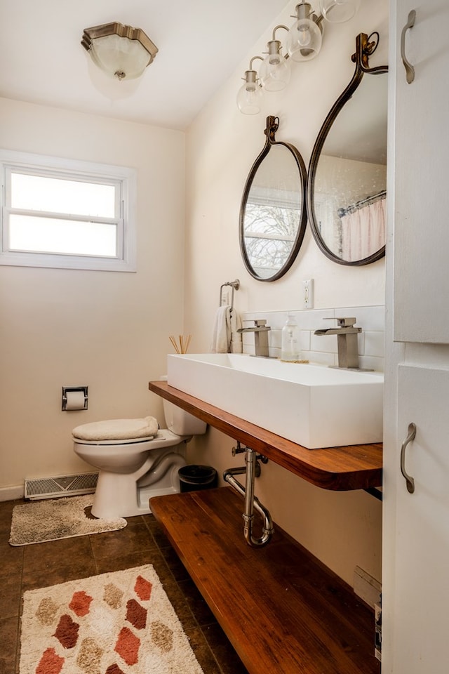 bathroom with tile patterned flooring, toilet, and sink