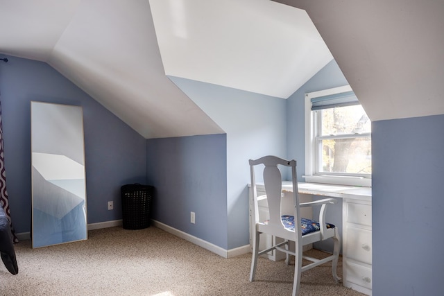 carpeted office space with lofted ceiling