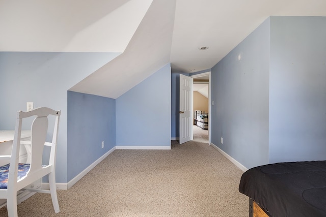 carpeted bedroom with vaulted ceiling