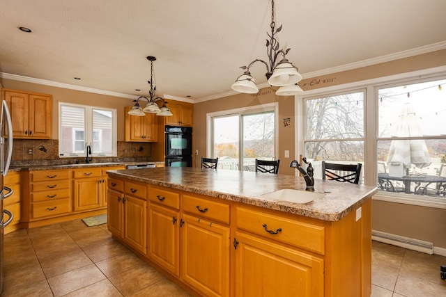 kitchen featuring a chandelier, a center island, decorative light fixtures, and sink