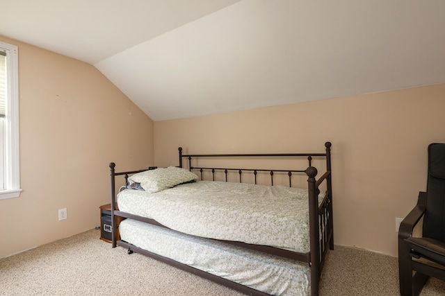 bedroom with carpet and lofted ceiling