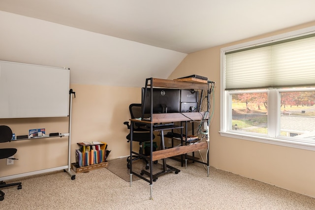 office with light carpet and lofted ceiling