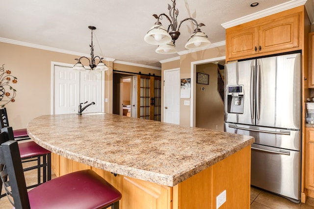 kitchen with a barn door, a center island, and stainless steel refrigerator with ice dispenser