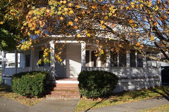 view of exterior entry featuring a porch