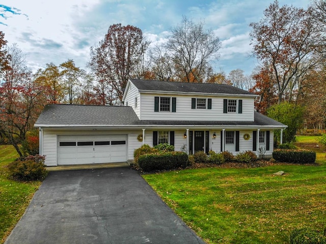 view of front of home with a front yard and a garage