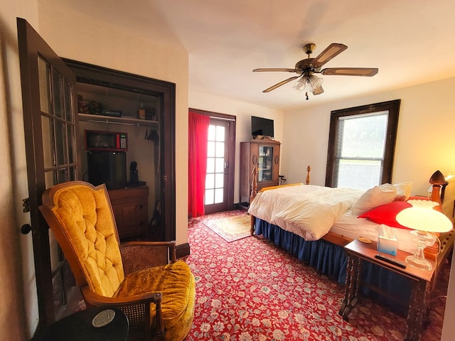 carpeted bedroom with ceiling fan and a closet