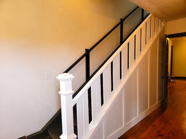 staircase with hardwood / wood-style floors