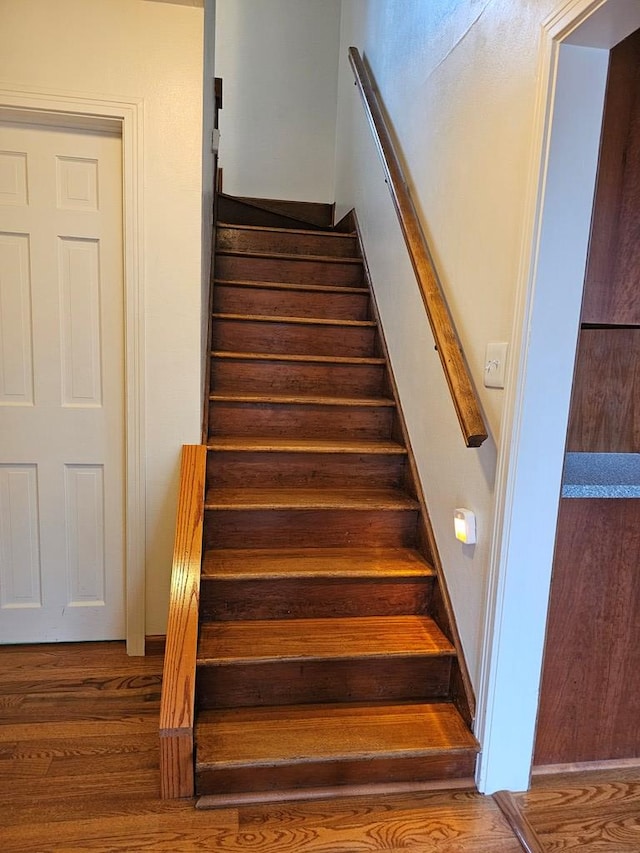 stairs with hardwood / wood-style flooring