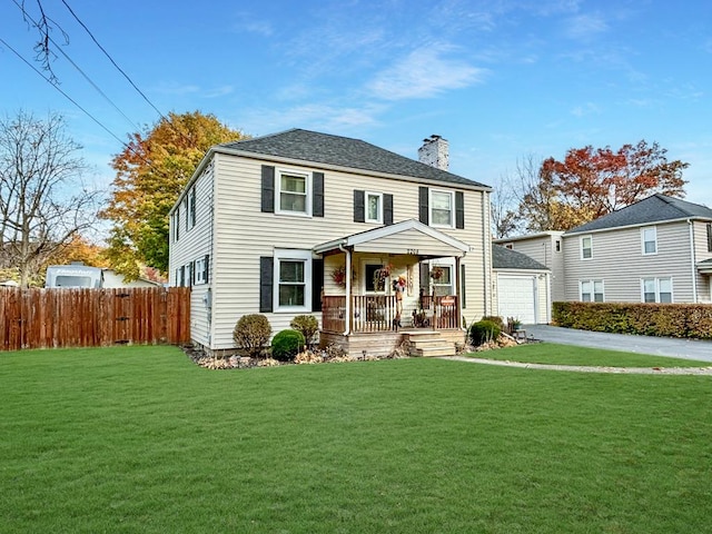 view of front of home featuring a porch, a garage, and a front yard