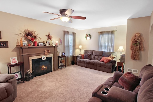 carpeted living room featuring ceiling fan