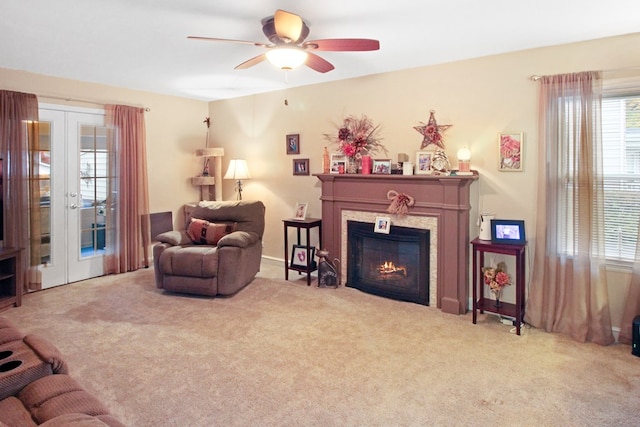 carpeted living room featuring french doors and ceiling fan